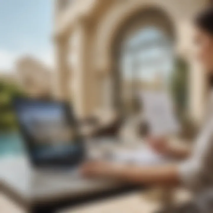 A person reviewing real estate documents on a laptop